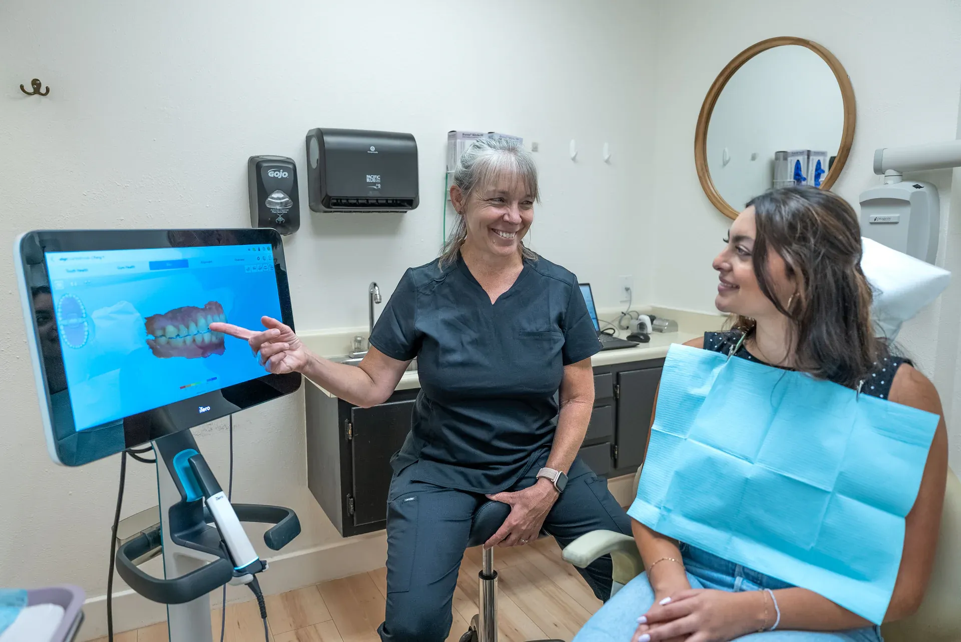 A Colorado Dental Spa hygienist reviewing a 3D digital scan on screen with a patient in Golden, CO