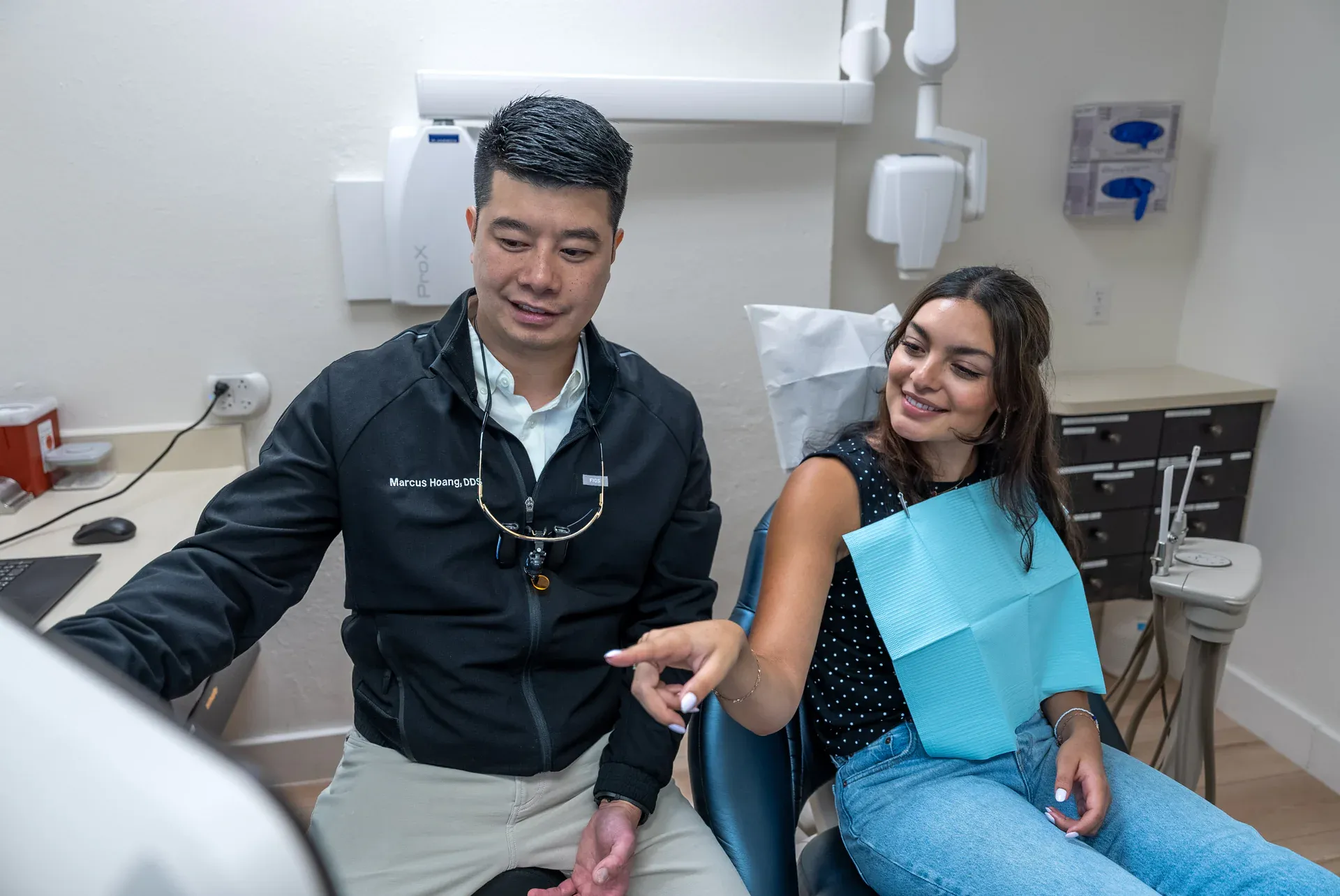 Dr. Marcus Hoang talking a patient through each step of her treatment at Colorado Dental Spa in Golden, CO