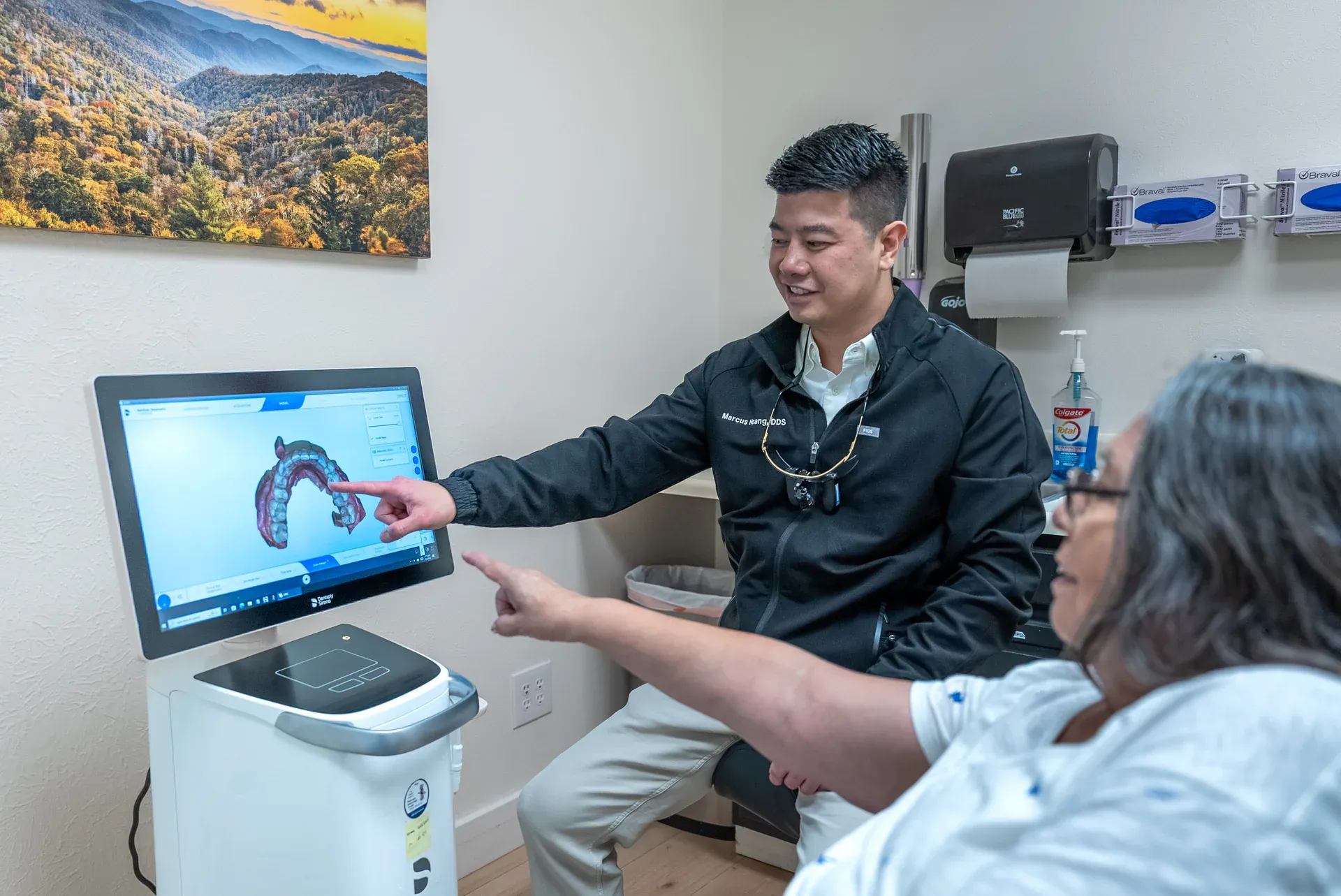 Dr. Marcus Hoang reviewing a digital scan with a patient at Colorado Dental Spa in Golden, CO